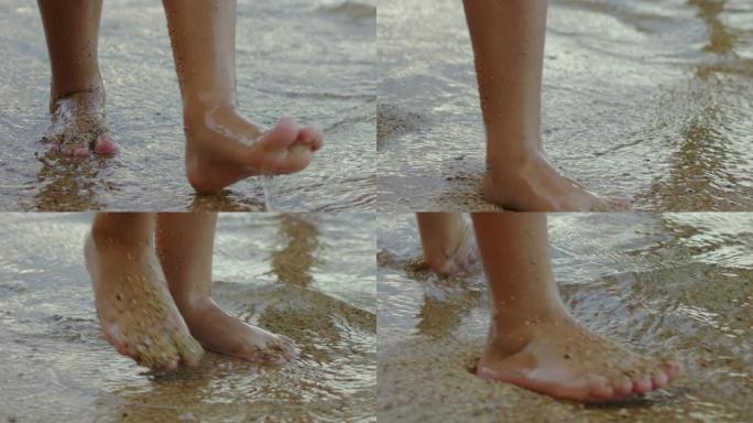 小女孩的脚在热带海滩上行走