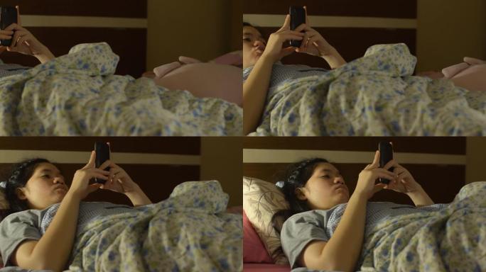顽皮的年轻女人睡觉玩手机