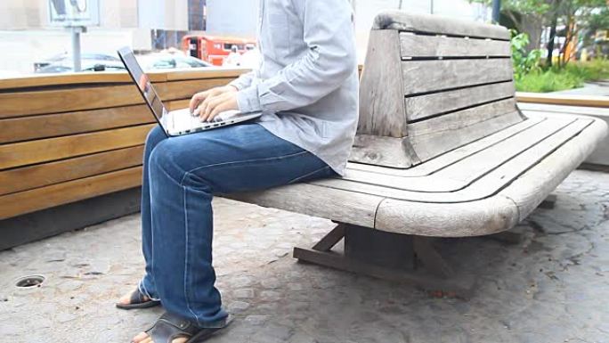 男人在笔记本电脑上工作，以便在清晨在户外完成所有业务