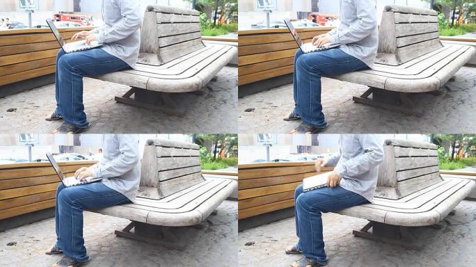 男人在笔记本电脑上工作，以便在清晨在户外完成所有业务