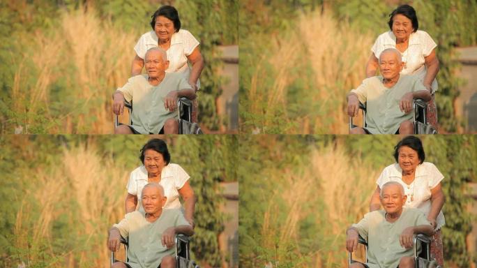 一位老年妇女在轮椅上推着残疾的手环