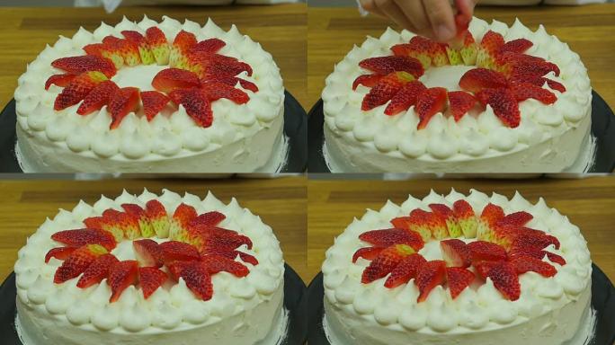 厨师用草莓慢动作装饰蛋糕