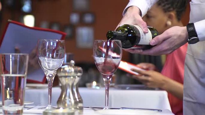 Waiter Pours Wine for Couple - Close Up