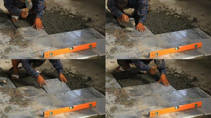 建筑工人铺设瓷砖地板。