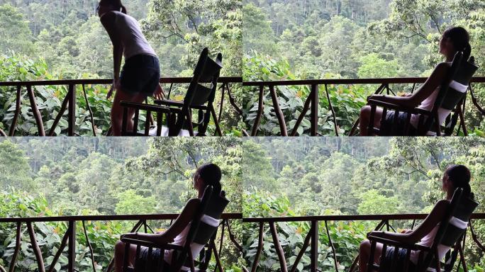 坐在摇椅上看雨林的女人