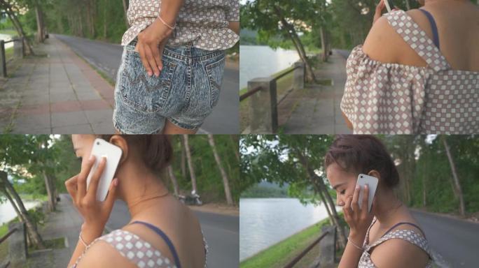 一名女子在公园里散步，用手机聊天，相机稳定器拍摄