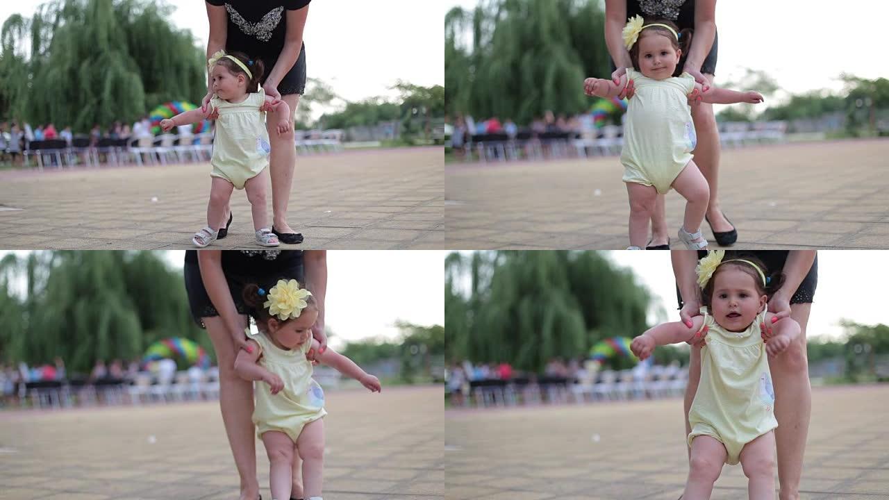 母亲学习她一岁的女婴走路，但她想被抱着