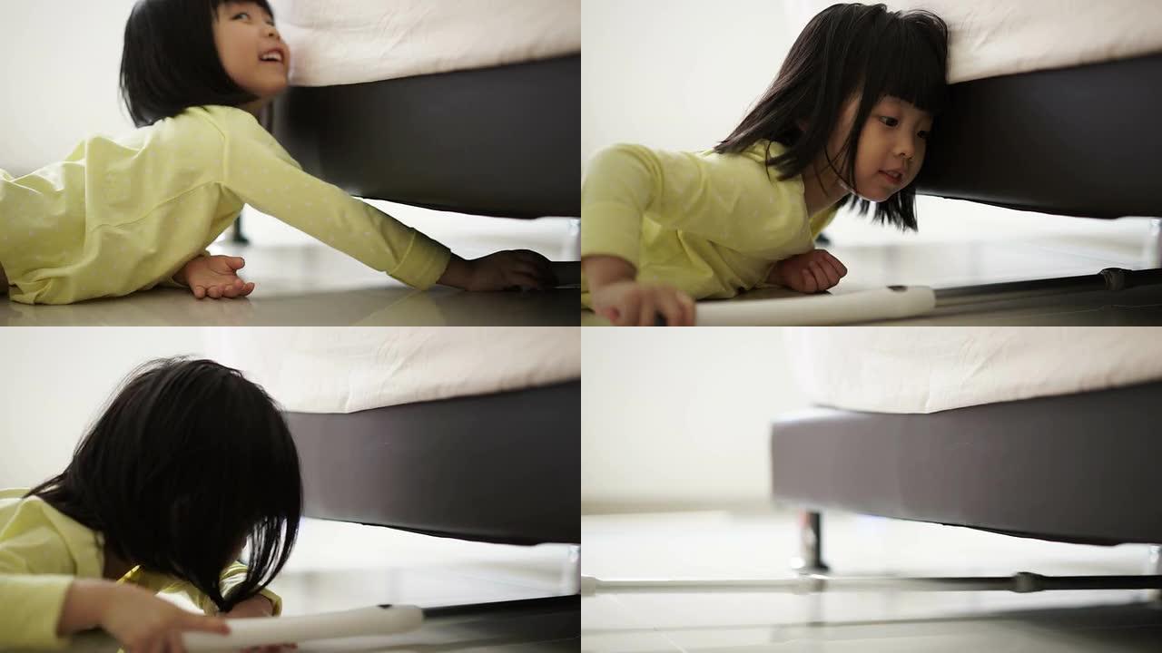 亚洲中国幼童努力清洁床下地板的特写