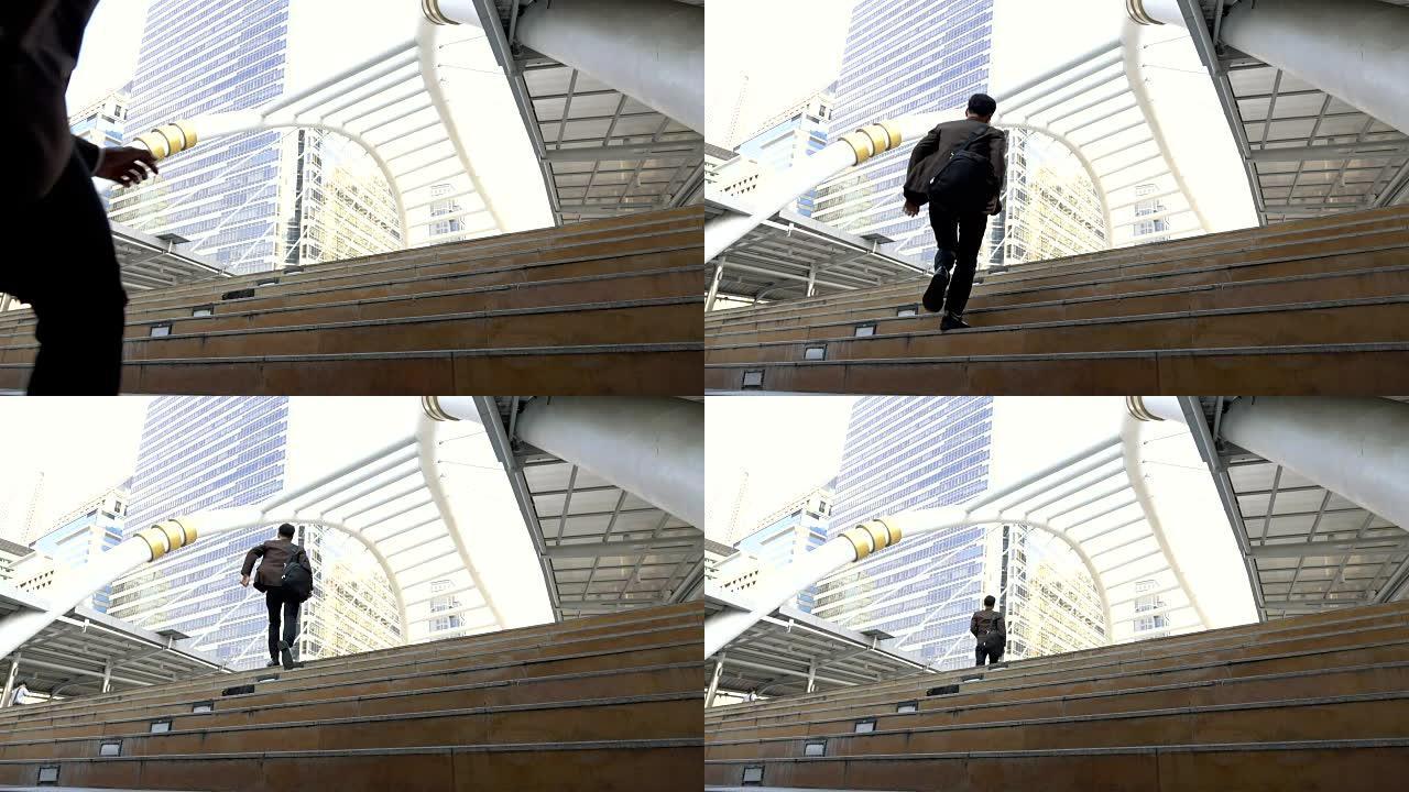 商人冲上楼梯在现代城市工作的慢动作镜头
