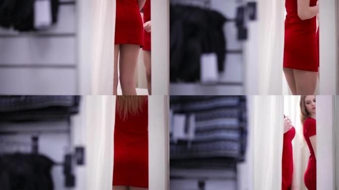 妇女在服装店试穿红色连衣裙