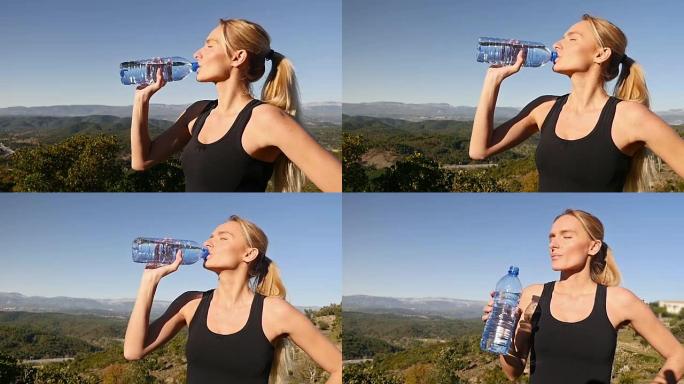 女孩在运动活动后喝水