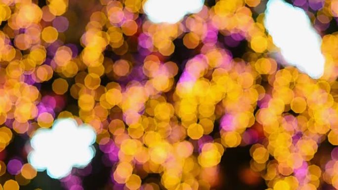 圣诞树上的黄色和粉红色散焦颗粒