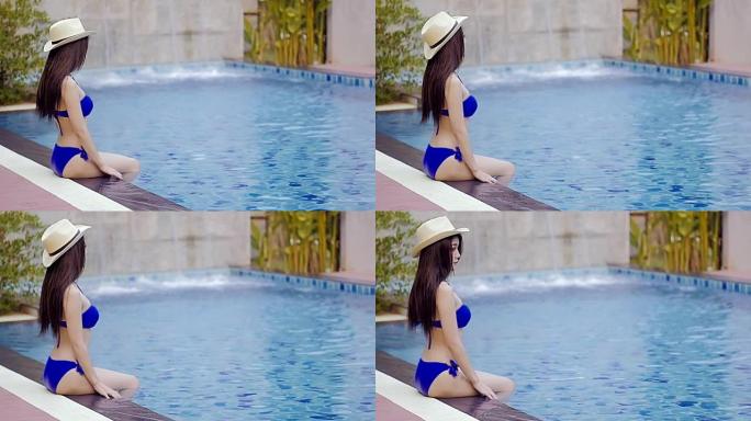游泳池里的亚洲年轻女子。慢动作。