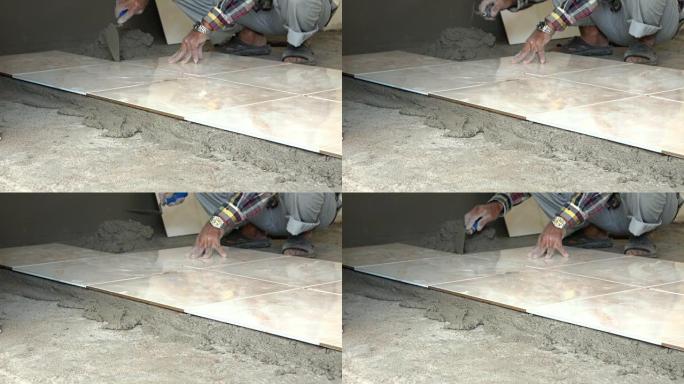 4k，建筑工人用油灰刀铺瓷砖地板