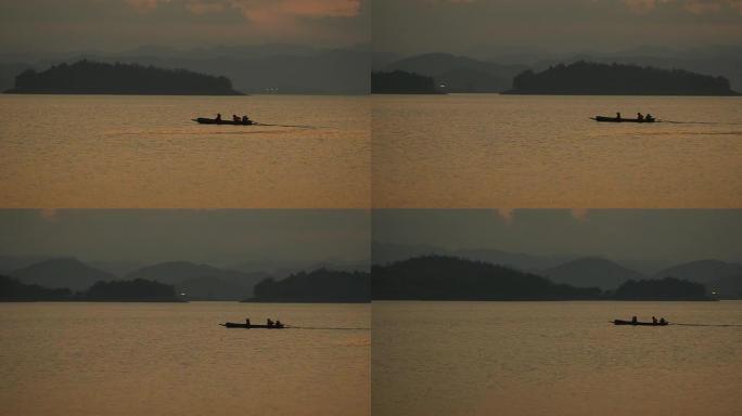 剪影：渔民们正乘坐长船在twlight大坝回家