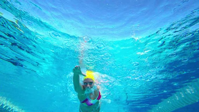 高清超慢Mo水下：年轻女子游泳前爬行