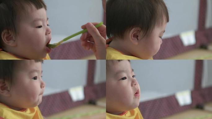 日本婴儿用勺子吃婴儿食品。
