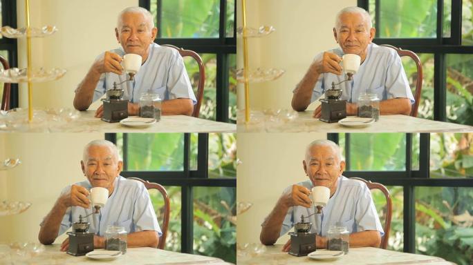 亚洲高级男子，带老式咖啡研磨机