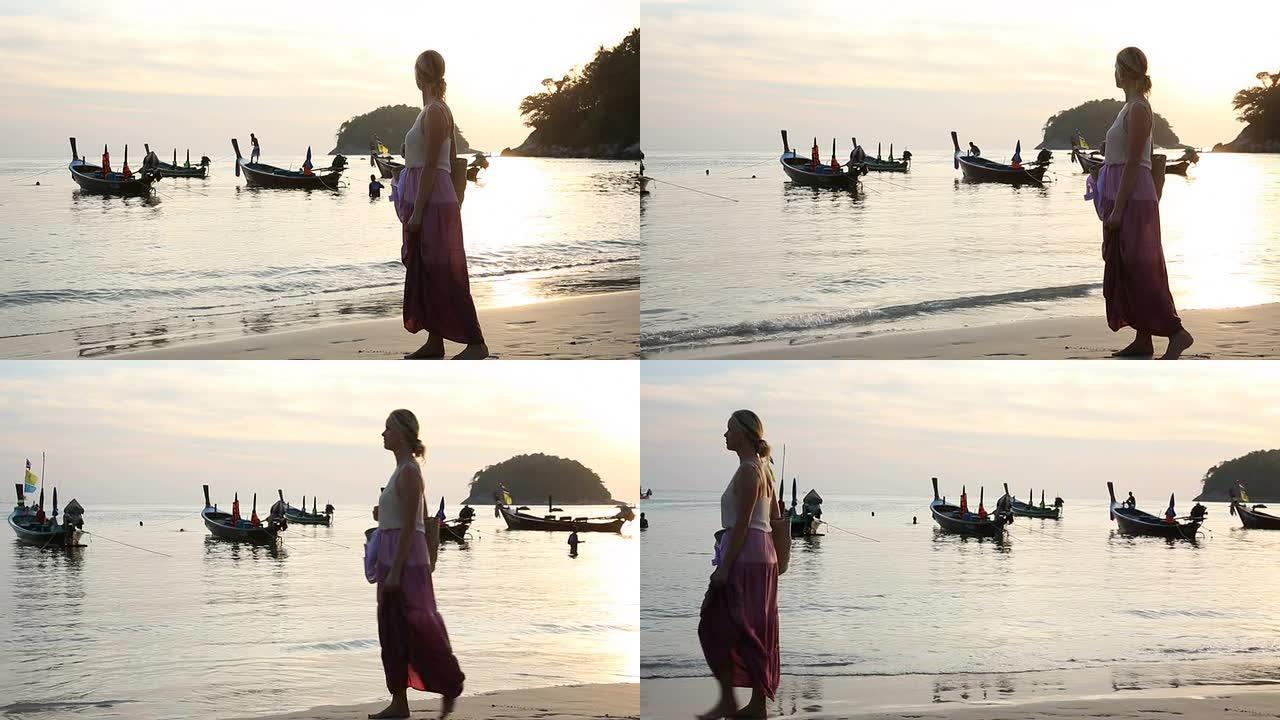 一名女子沿着海滩散步，眺望浅滩上的船只
