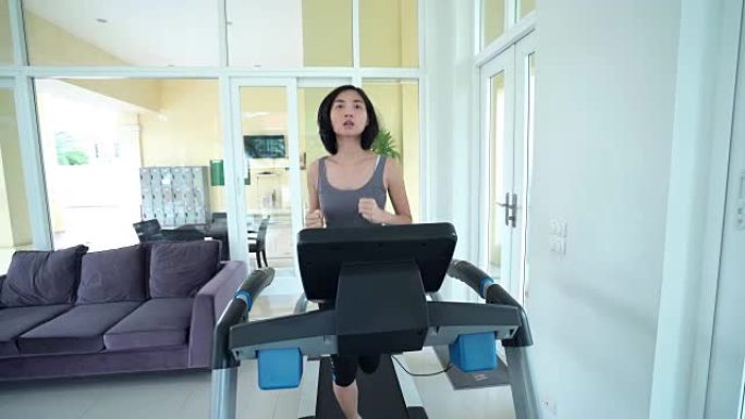 多莉拍摄了在跑步机上跑步的亚洲美女