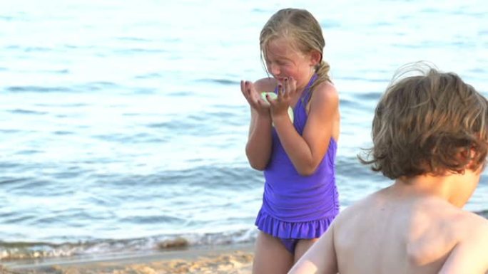 慢镜头女孩在海滩上抓水球