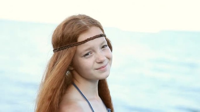 美丽的红发少女在海边放松