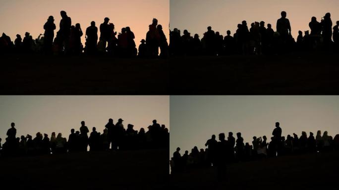 平移和剪影：人们在等待日出