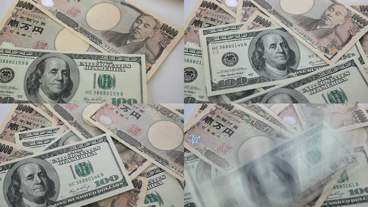 数着一百美元和日元的钞票。