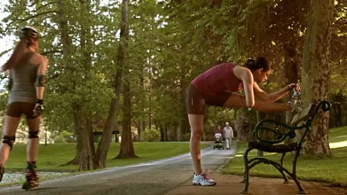 DS女跑步者在公园长椅上伸展