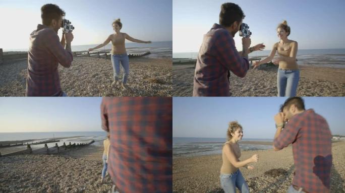 海滩上的年轻情侣和摄像机