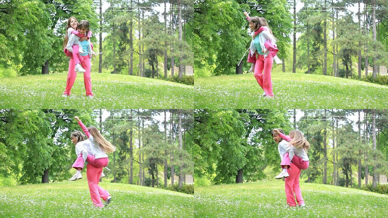 母亲和女儿在绿色公园里玩耍。