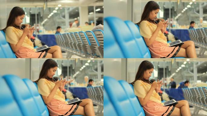 一名女子在机场使用数字平板电脑