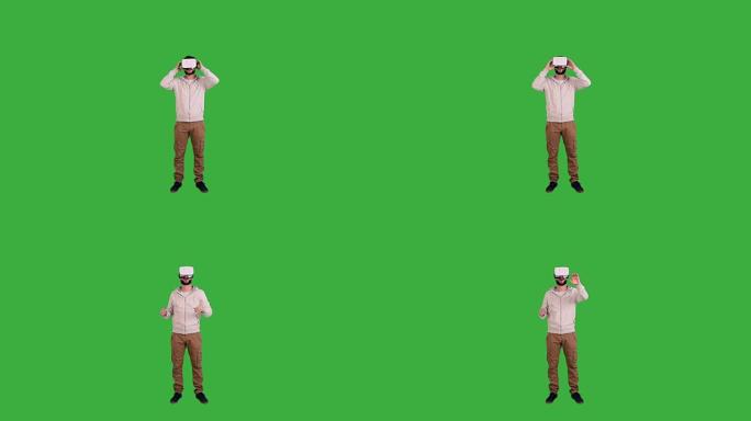 男人戴着眼镜虚拟现实并在绿色背景上享受