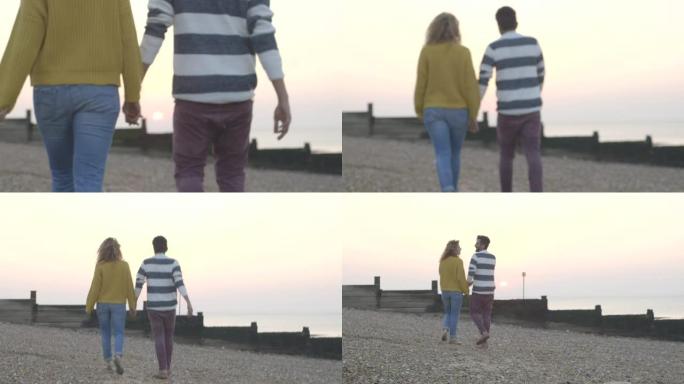 海滩上的情侣情侣牵手背影
