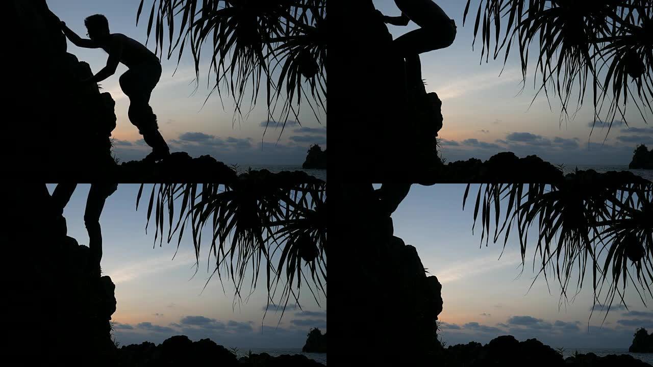 日落时岩石上男人的剪影