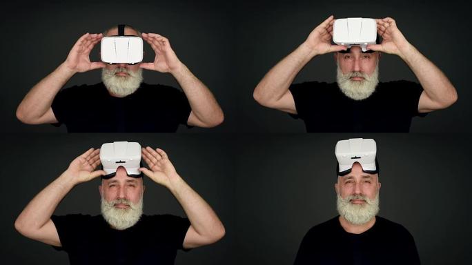 胡子老人摘下虚拟现实眼镜，在黑色背景下直接看着相机