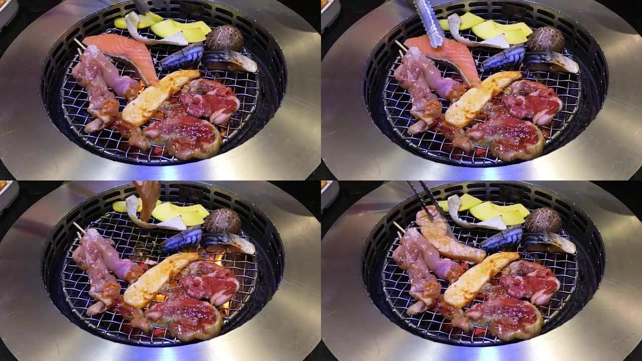 在热木炭烤架上烧烤日本风格的肉类和海鲜