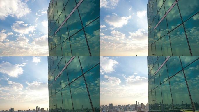 美丽的云彩和蓝天映在公司办公楼的镜面窗户上。