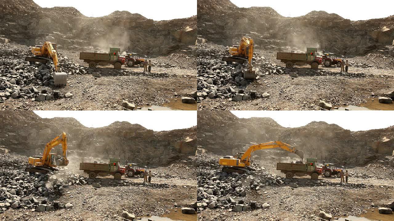 推土机在采矿现场工作，用卡车装载石块