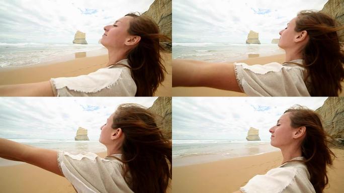 澳大利亚吉布森斯台阶海滩上伸出的年轻女子手臂
