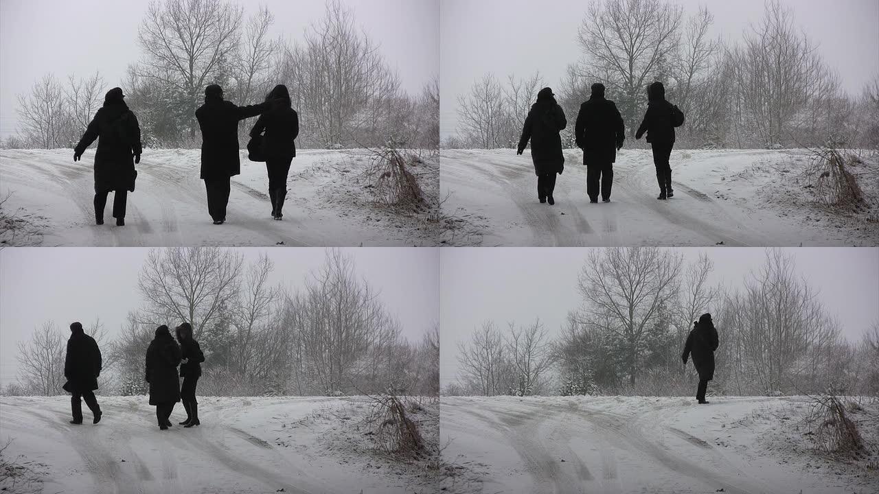 边走路边说话冬季景色三个人走路背影