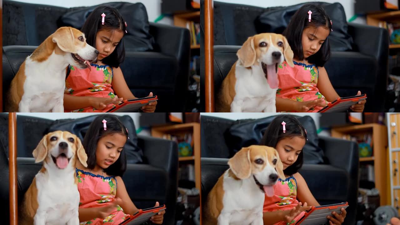非洲小女孩在用平板电脑，她的小猎犬在看平板电脑