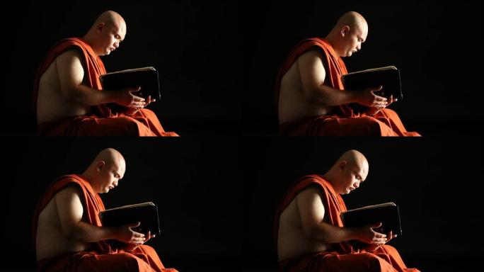 佛教僧侣在黑暗中阅读圣书