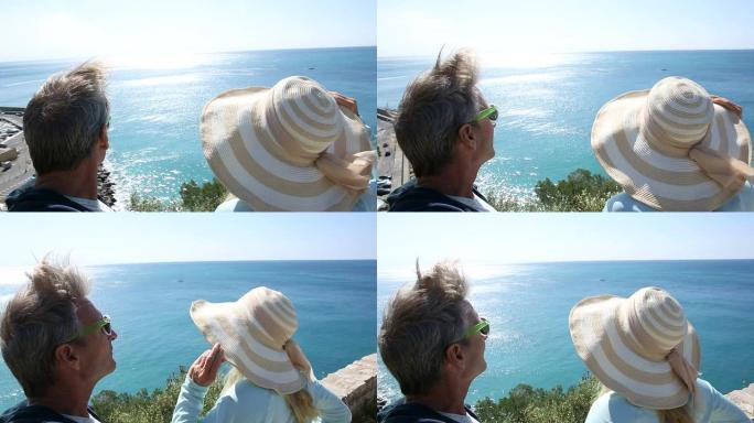 夫妇从海角望向广阔的大海