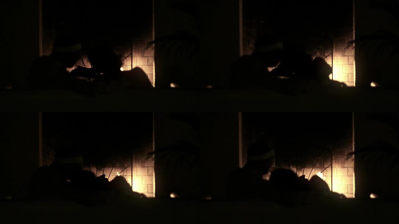 情侣剪影在壁炉前接吻