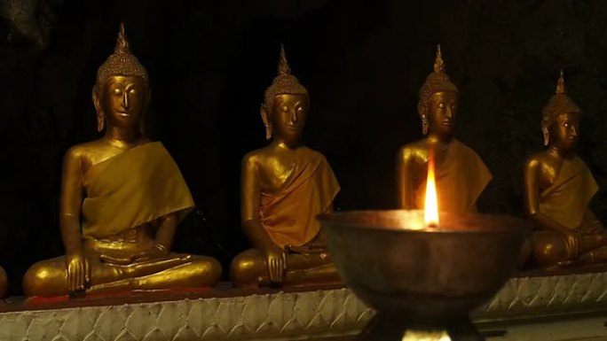 佛像和燃烧的蜡烛