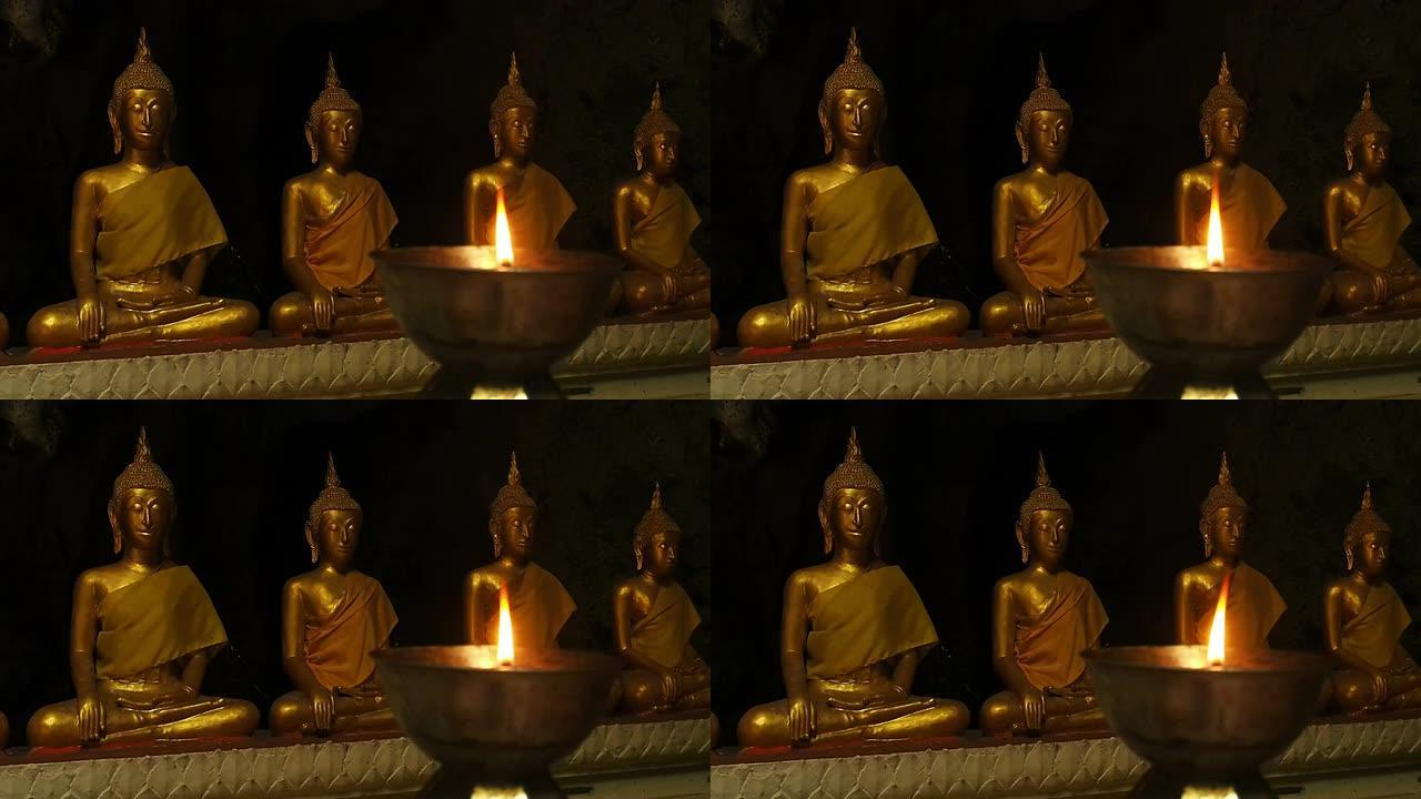 佛像和燃烧的蜡烛