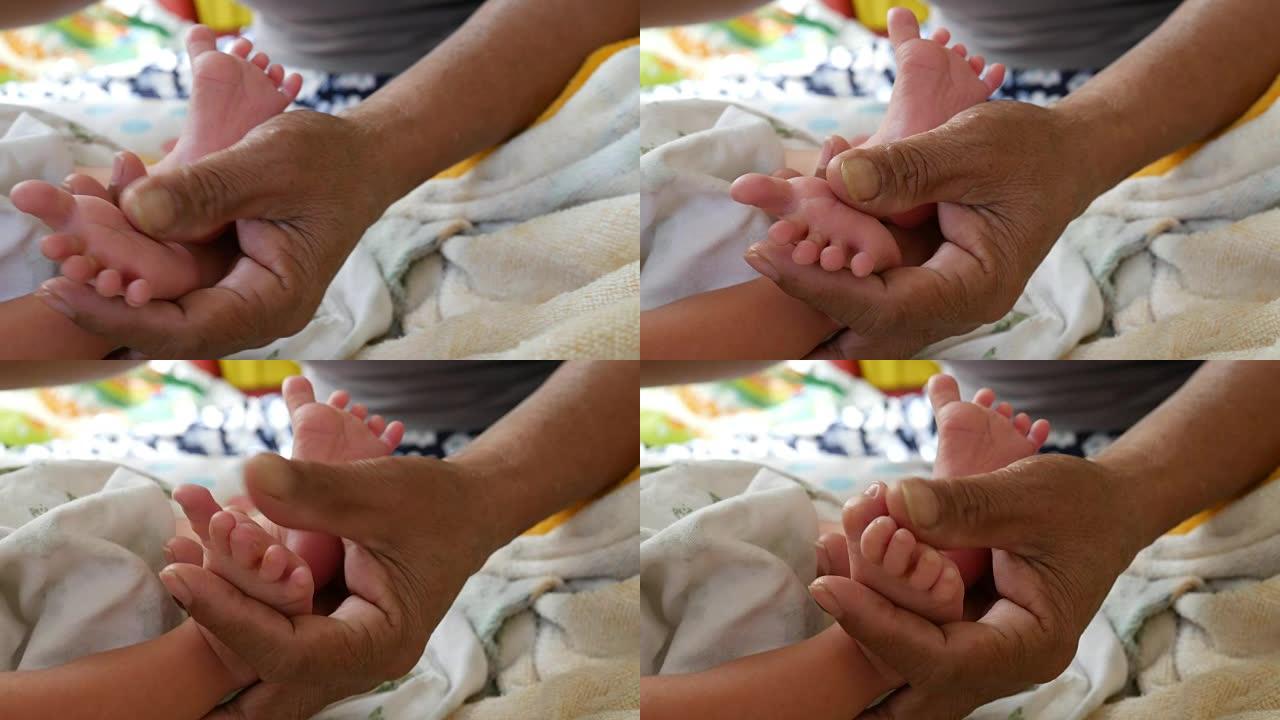 婴儿的脚在母亲的手中。新生婴儿的脚在女性身上
