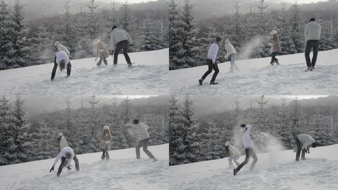 年轻人滚雪球打雪仗冰雪运动冬天扔雪球