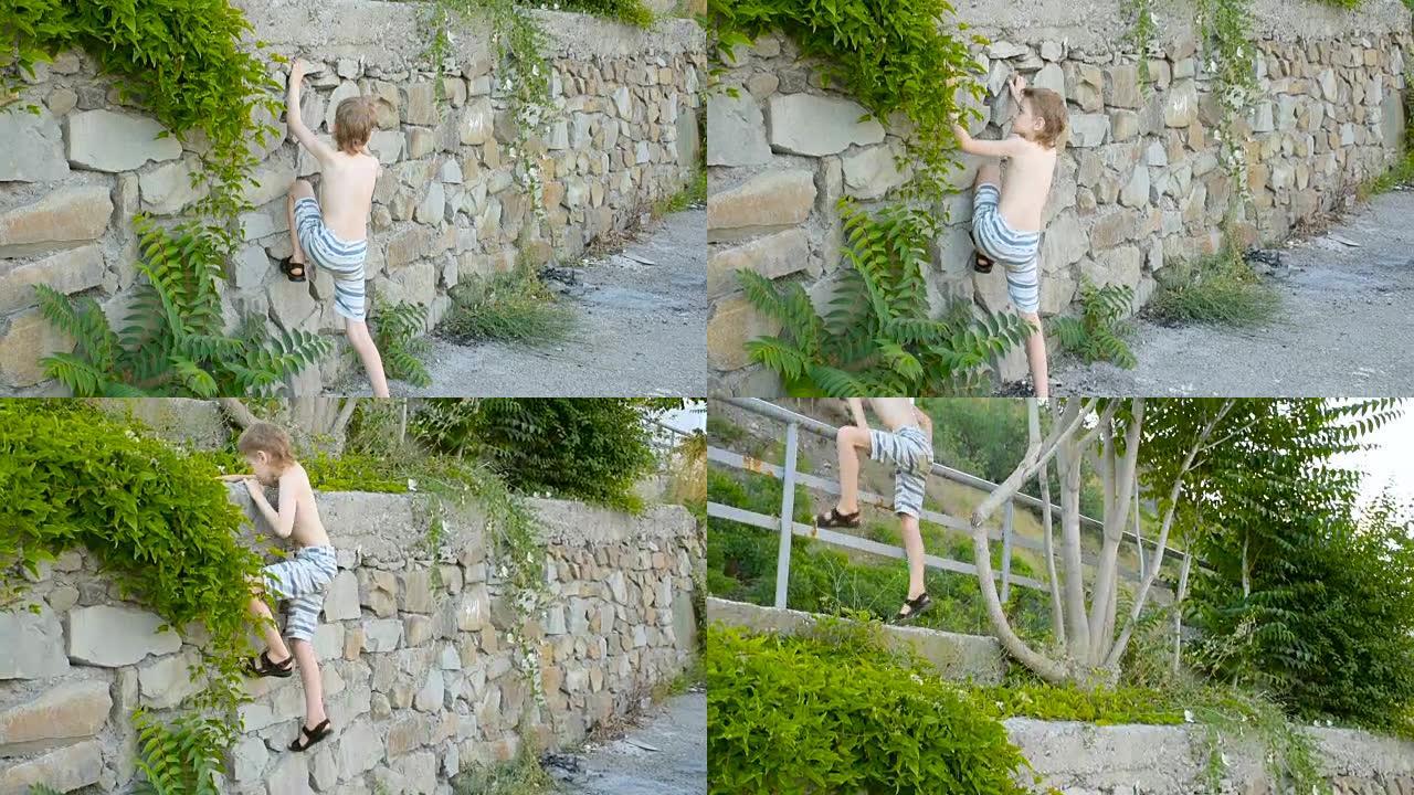 男孩爬上石头挡土墙